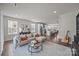 Spacious living room with hardwood floors connecting to the kitchen and dining area at 1037 Naples Dr, Davidson, NC 28036