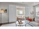 Inviting living room with a glass table and access to a cozy outdoor patio with shuttered doors at 1037 Naples Dr, Davidson, NC 28036
