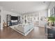 Bright living room with hardwood floors, a large sofa, and access to the balcony at 1037 Naples Dr, Davidson, NC 28036