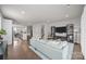 Open-concept living room with hardwood floors connecting to the kitchen and dining area at 1037 Naples Dr, Davidson, NC 28036