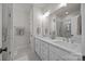 Main bathroom features double sinks, white cabinets, and a walk-in shower with glass door at 1037 Naples Dr, Davidson, NC 28036