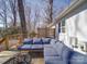 Inviting back deck featuring a comfortable outdoor lounge area with a fire pit and tranquil backyard view at 10514 Lorelei Pl, Charlotte, NC 28227