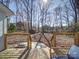 Backyard view from the deck, with ample greenery and a storage shed for convenience at 10514 Lorelei Pl, Charlotte, NC 28227