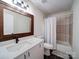 Modern bathroom boasts a quartz countertop vanity, framed mirror, and a shower-tub combo for a spa-like experience at 10514 Lorelei Pl, Charlotte, NC 28227