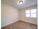 Bright bedroom featuring neutral walls, hardwood flooring, and a window providing plenty of natural light at 10514 Lorelei Pl, Charlotte, NC 28227