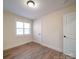 This cozy bedroom features natural light and beautiful hardwood flooring, creating a warm and inviting space at 10514 Lorelei Pl, Charlotte, NC 28227