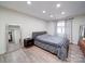 Bedroom showcasing wood floors, neutral paint, and window that brings in natural light at 10514 Lorelei Pl, Charlotte, NC 28227