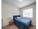 Comfortable bedroom with wood floors, neutral paint and a large window at 10514 Lorelei Pl, Charlotte, NC 28227