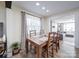 Bright dining room showcasing wood floors, a large window and an open concept into the living room at 10514 Lorelei Pl, Charlotte, NC 28227