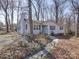 Charming home with a brick chimney, light blue door, and a walkway lined with lights at 10514 Lorelei Pl, Charlotte, NC 28227