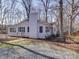 The white exterior with black shutters is accented by a tall brick chimney at 10514 Lorelei Pl, Charlotte, NC 28227
