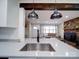 Kitchen view with stainless steel sink and a view of the living room fireplace at 10514 Lorelei Pl, Charlotte, NC 28227