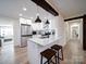 Modern kitchen with stainless steel refrigerator and a view of the living room at 10514 Lorelei Pl, Charlotte, NC 28227