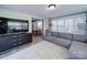 Living room with large television, comfortable seating and open layout to the dining room at 10514 Lorelei Pl, Charlotte, NC 28227