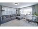 Cozy living room featuring a neutral color palette, large windows, and a comfortable sectional sofa at 10514 Lorelei Pl, Charlotte, NC 28227
