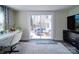 Bright living room with desk area and sliding glass doors that open to the outdoor patio space at 10514 Lorelei Pl, Charlotte, NC 28227