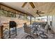 Spacious covered back deck featuring ceiling fans, grill, and outdoor dining furniture at 10722 Mountain Springs Dr, Charlotte, NC 28278