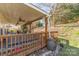 Covered back deck with ceiling fans and outdoor seating overlooks the tree-lined backyard at 10722 Mountain Springs Dr, Charlotte, NC 28278