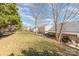 Spacious backyard featuring a wooden deck, lush lawn, and mature trees, creating a serene outdoor living space at 10722 Mountain Springs Dr, Charlotte, NC 28278