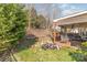 The covered back porch overlooks the backyard complete with landscaping and trees at 10722 Mountain Springs Dr, Charlotte, NC 28278
