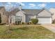 Charming home featuring an attached two-car garage, tidy landscaping, and light siding at 10722 Mountain Springs Dr, Charlotte, NC 28278