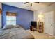 Bedroom showcasing blue accent wall, and natural light at 11010 Pale Hickory Ln, Charlotte, NC 28215