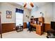 Comfortable home office with functional desk, ceiling fan, and natural light creates a productive workspace at 11010 Pale Hickory Ln, Charlotte, NC 28215