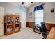 Office space with a wall-to-wall bookshelf, desk, and natural light, provides a well-organized workspace at 11010 Pale Hickory Ln, Charlotte, NC 28215