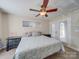 A comfortable bedroom featuring a ceiling fan, bedside tables, and an exterior door to a patio at 1162 W 1St St, Charlotte, NC 28202