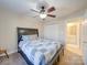 Bedroom features a ceiling fan, closet, and adjacent bathroom entrance at 1162 W 1St St, Charlotte, NC 28202