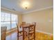A well-lit dining area with hardwood floors, a large window, and seating for four at 1162 W 1St St, Charlotte, NC 28202