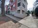 A ground-level exterior view showcasing the side of the building with a walkway at 1162 W 1St St, Charlotte, NC 28202