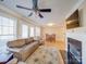 Spacious living room with fireplace, tv, hardwood floors, a ceiling fan, and comfortable seating at 1162 W 1St St, Charlotte, NC 28202