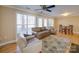 Bright living room with hardwood floors, a ceiling fan, large windows, and comfortable seating at 1162 W 1St St, Charlotte, NC 28202