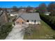 Aerial view showcasing a single-Gathering home with brick exterior, porch, and driveway at 12012 Stainsby Ln, Charlotte, NC 28273