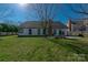 Large backyard with a lawn, fire pit, and a patio is perfect for outdoor enjoyment at 12012 Stainsby Ln, Charlotte, NC 28273