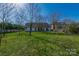 Spacious backyard featuring lush green grass and mature trees perfect for outdoor activities at 12012 Stainsby Ln, Charlotte, NC 28273