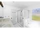 Bright bathroom featuring double vanity, a tub, and tiled shower at 12012 Stainsby Ln, Charlotte, NC 28273