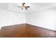 Neutral bedroom featuring tray ceilings, hardwood floors, and a ceiling fan at 12012 Stainsby Ln, Charlotte, NC 28273