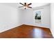 Bedroom with wood floors, a ceiling fan, and views of the landscaped yard at 12012 Stainsby Ln, Charlotte, NC 28273