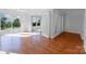 Spacious living room with hardwood floors, sliding glass doors to the yard, and views to the exterior at 12012 Stainsby Ln, Charlotte, NC 28273