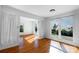 Open living room with hardwood floors and large windows offering natural light and exterior views at 12012 Stainsby Ln, Charlotte, NC 28273