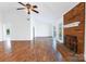 Spacious living room with high ceilings, a fan, fireplace, and backyard access at 12012 Stainsby Ln, Charlotte, NC 28273