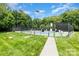 Community tennis court with green and blue surface, surrounded by lush landscaping at 12012 Stainsby Ln, Charlotte, NC 28273