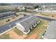 Aerial view of brick townhouses surrounded by parking areas and green spaces, offering a glimpse of community layout at 1205 Skywatch Ln, Monroe, NC 28112