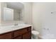 Bright bathroom with a single sink vanity, white toilet, and shower at 1205 Skywatch Ln, Monroe, NC 28112