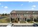 Brick townhomes with well-maintained landscaping and convenient parking spaces at 1205 Skywatch Ln, Monroe, NC 28112