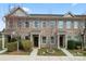 Charming brick townhome with manicured landscaping and welcoming front entrances at 1205 Skywatch Ln, Monroe, NC 28112