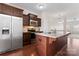 Kitchen with stainless steel refrigerator, microwave, range, and island with sink at 1205 Skywatch Ln, Monroe, NC 28112