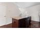 Bright kitchen island with stainless dishwasher, sink and stairs in the background at 1205 Skywatch Ln, Monroe, NC 28112